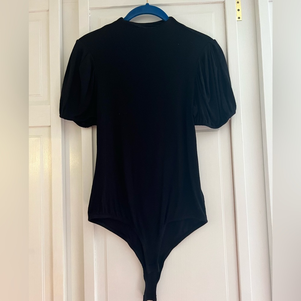 Black rib knit bodysuit with short puffy sleeves. Size S